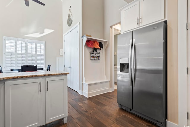 6624 Lagoon Pl, Myrtle Beach, SC 29572 - kitchen featuring stainless steel fridge, dark wood-style flooring, ceiling fan, light stone counters, and white cabinetry