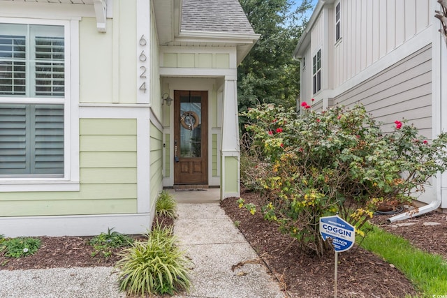6624 Lagoon Pl, Myrtle Beach, SC 29572 - doorway to property with board and batten siding and roof with shingles
