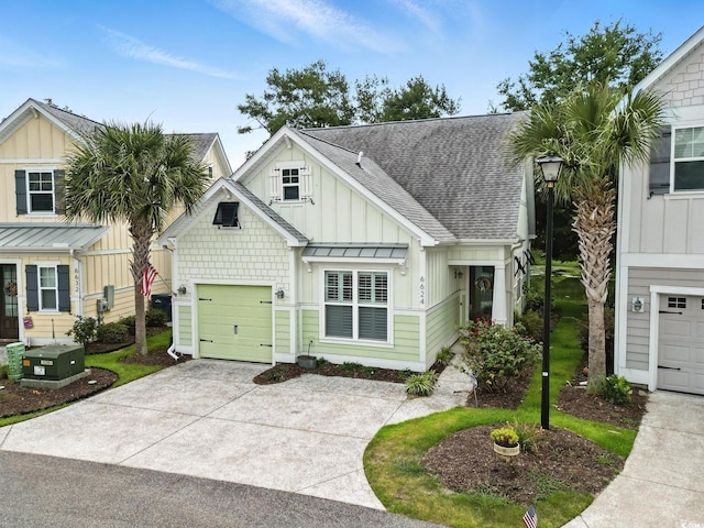6624 Lagoon Pl, Myrtle Beach, SC 29572 - view of front of house featuring board and batten siding, roof with shingles, and driveway