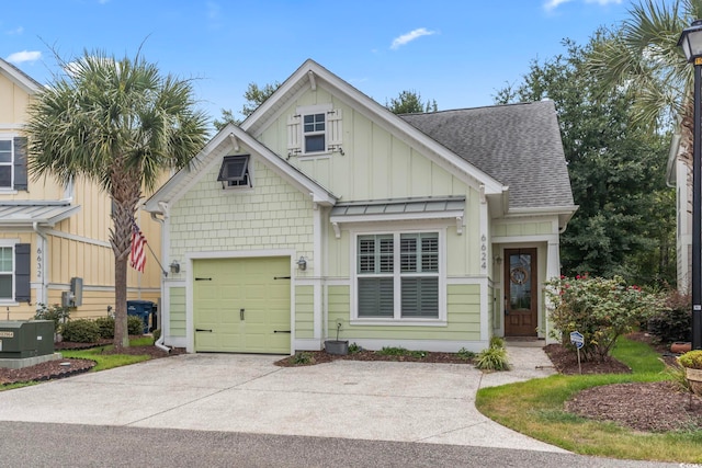 6624 Lagoon Pl, Myrtle Beach, SC 29572 - view of front of home with board and batten siding, roof with shingles, driveway, a standing seam roof, and a garage