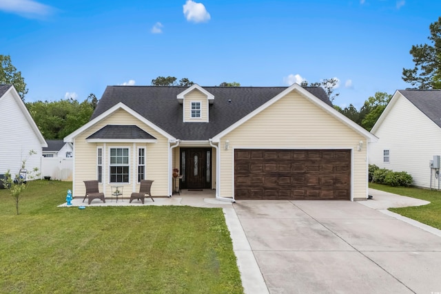 2395 Morlynn Dr, Myrtle Beach, SC 29577 - view of front facade featuring a garage, driveway, a front yard, and roof with shingles