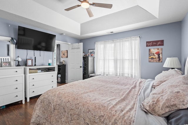 2395 Morlynn Dr, Myrtle Beach, SC 29577 - bedroom with dark wood-style flooring, a tray ceiling, and ceiling fan