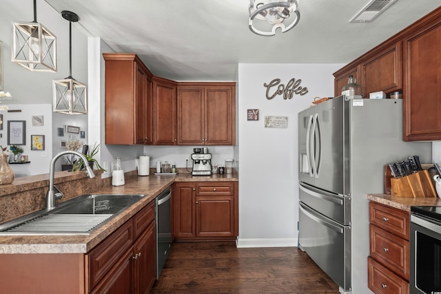 2395 Morlynn Dr, Myrtle Beach, SC 29577 - kitchen with dark wood-style floors, appliances with stainless steel finishes, a peninsula, a chandelier, and decorative light fixtures