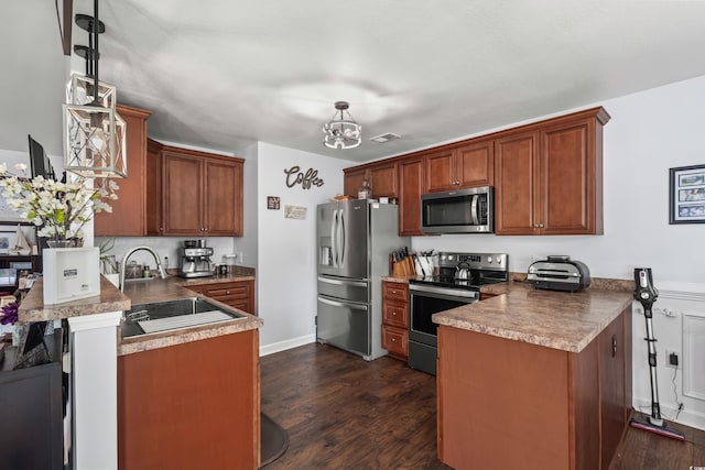 2395 Morlynn Dr, Myrtle Beach, SC 29577 - kitchen with appliances with stainless steel finishes, a peninsula, a chandelier, dark wood-style flooring, and brown cabinets