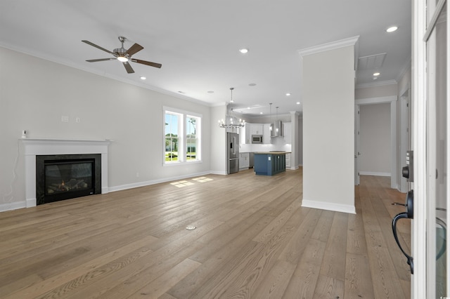 8148 Living Tide Dr, Myrtle Beach, SC 29572 - unfurnished living room featuring crown molding, a ceiling fan, a glass covered fireplace, light wood finished floors, and recessed lighting
