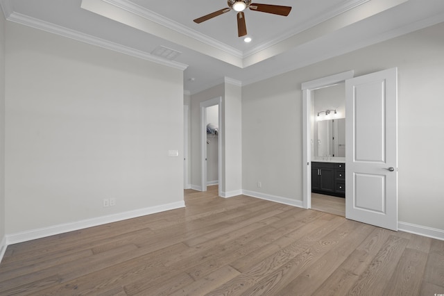 8148 Living Tide Dr, Myrtle Beach, SC 29572 - unfurnished bedroom with crown molding, light wood finished floors, a raised ceiling, connected bathroom, and recessed lighting