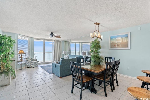 5404 N Ocean Blvd Unit 11-D, North Myrtle Beach, SC 29582 - dining space with light tile patterned floors, a textured ceiling, a ceiling fan, floor to ceiling windows, and a chandelier
