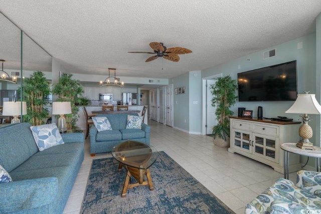 5404 N Ocean Blvd Unit 11-D, North Myrtle Beach, SC 29582 - living room with light tile patterned floors, ceiling fan, a textured ceiling, and a chandelier