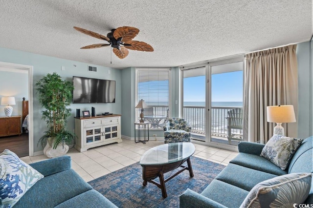 5404 N Ocean Blvd Unit 11-D, North Myrtle Beach, SC 29582 - living room with tile patterned flooring, a ceiling fan, and a textured ceiling