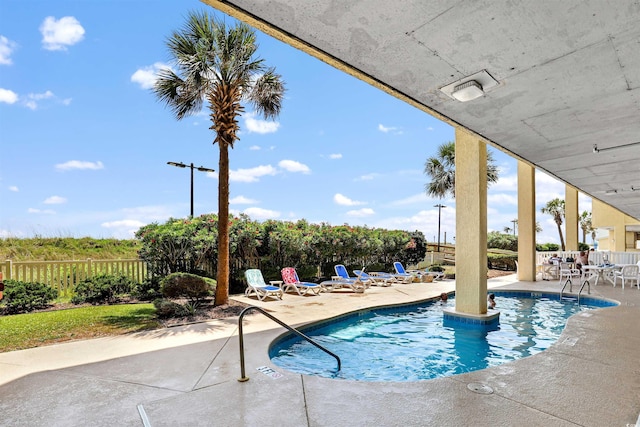 5404 N Ocean Blvd Unit 11-D, North Myrtle Beach, SC 29582 - community pool with a patio area and a fenced backyard