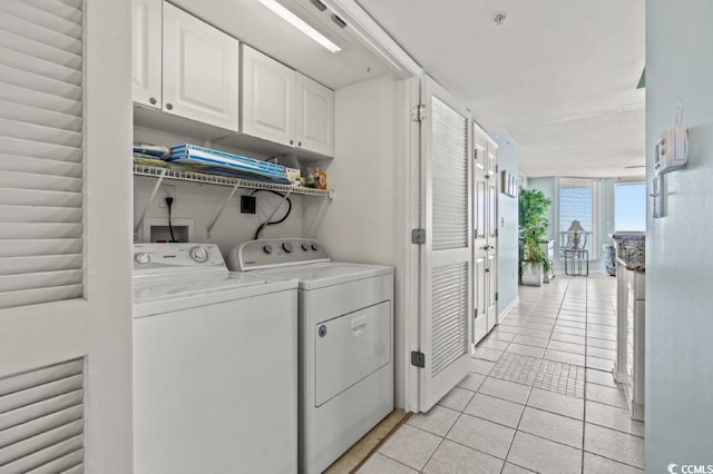 5404 N Ocean Blvd Unit 11-D, North Myrtle Beach, SC 29582 - washroom with cabinet space, washer and clothes dryer, and light tile patterned flooring