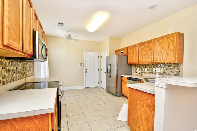 501 Painted Duck Ct, Myrtle Beach, SC 29588 - kitchen featuring stainless steel appliances, light countertops, ceiling fan, and decorative backsplash