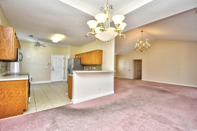 501 Painted Duck Ct, Myrtle Beach, SC 29588 - kitchen featuring stainless steel appliances, a chandelier, brown cabinetry, tasteful backsplash, and a textured ceiling
