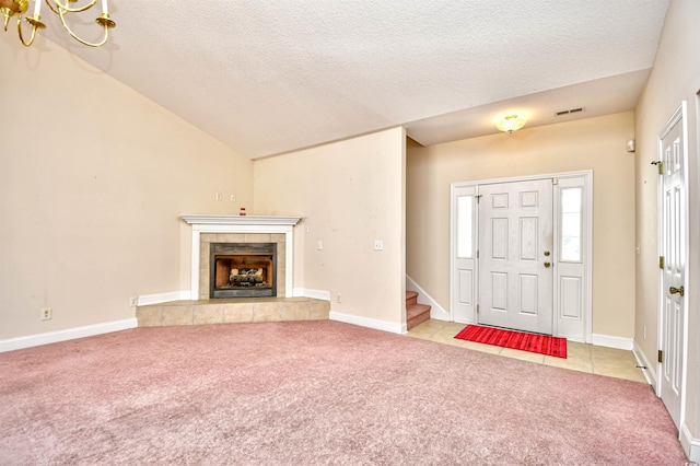 501 Painted Duck Ct, Myrtle Beach, SC 29588 - tiled foyer entrance with carpet, stairs, a textured ceiling, and a fireplace