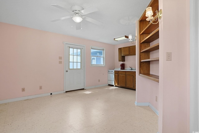 804 47th Ave N, Myrtle Beach, SC 29577 - kitchen with brown cabinets, a ceiling fan, open shelves, light countertops, and light floors