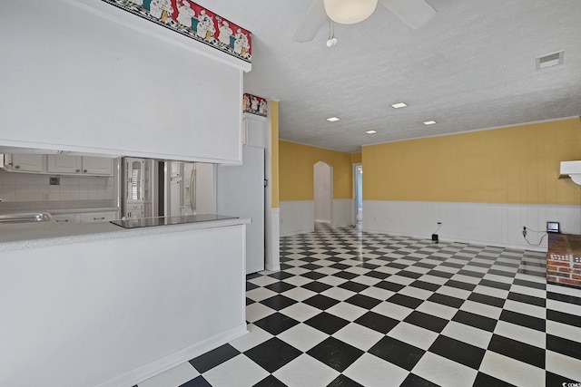804 47th Ave N, Myrtle Beach, SC 29577 - unfurnished room with light flooring, arched walkways, wainscoting, and a ceiling fan