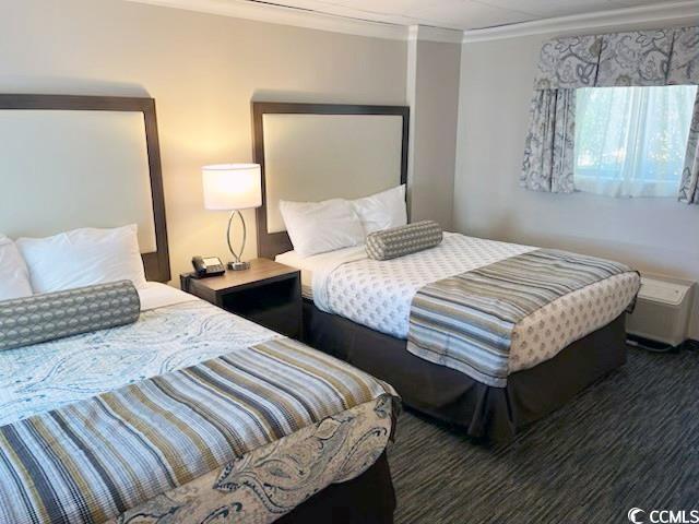 1105 S Ocean Blvd Unit 136, Myrtle Beach, SC 29577 - bedroom with crown molding and wood finished floors