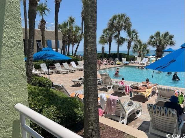 1105 S Ocean Blvd Unit 136, Myrtle Beach, SC 29577 - community pool with a patio area and an outdoor living space