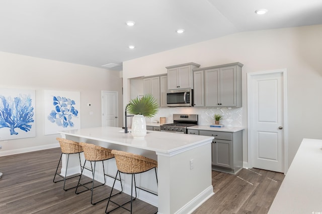 197 Bantry Ln, Conway, SC 29526 - kitchen with gray cabinets, stainless steel appliances, dark wood finished floors, a kitchen island with sink, and lofted ceiling