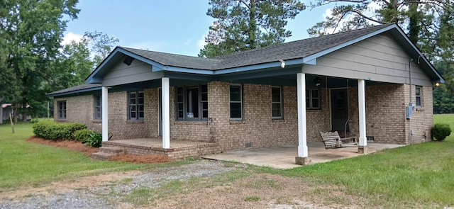 1206 French Rd, Mullins, SC 29574 - view of side of property with a lawn, driveway, a patio, a shingled roof, and brick siding
