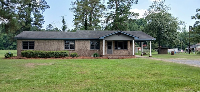 1206 French Rd, Mullins, SC 29574 - ranch-style house with covered porch, a front lawn, and brick siding