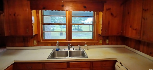 1206 French Rd, Mullins, SC 29574 - kitchen featuring plenty of natural light, light countertops, baseboard heating, and brown cabinetry