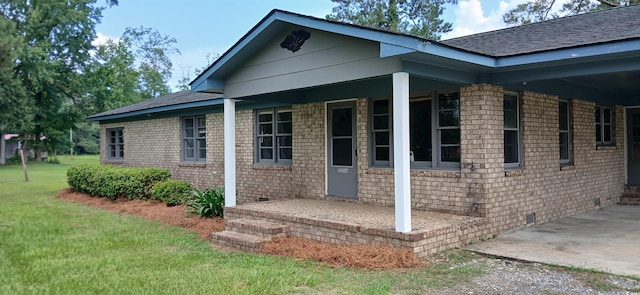 1206 French Rd, Mullins, SC 29574 - entrance to property featuring a lawn, a carport, crawl space, brick siding, and roof with shingles