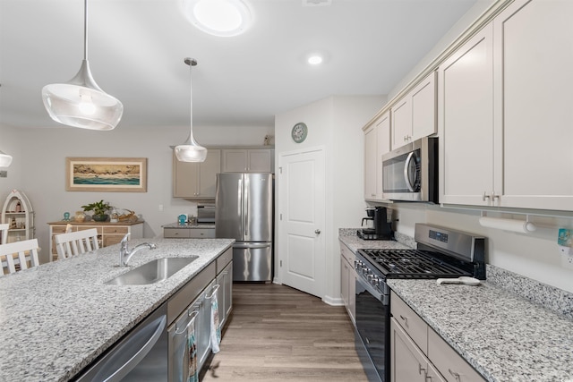 2438 Polaris Path, Myrtle Beach, SC 29577 - kitchen with stainless steel appliances, light wood-style floors, hanging light fixtures, and light stone counters