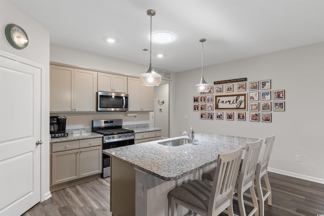 2438 Polaris Path, Myrtle Beach, SC 29577 - kitchen featuring appliances with stainless steel finishes, dark wood-style floors, a breakfast bar, light stone countertops, and recessed lighting