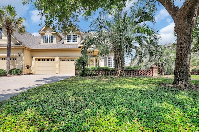 431 Huntington Lake Cir Unit 80, Pawleys Island, SC 29585 - view of front facade featuring driveway, a front lawn, an attached garage, and a shingled roof