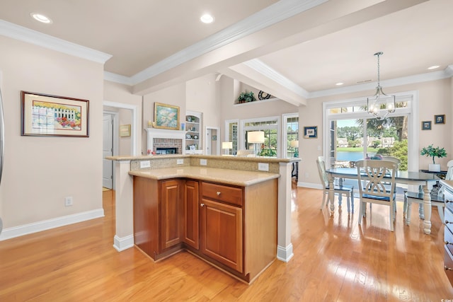 431 Huntington Lake Cir Unit 80, Pawleys Island, SC 29585 - kitchen with brown cabinetry, light wood-style floors, a brick fireplace, open floor plan, and pendant lighting