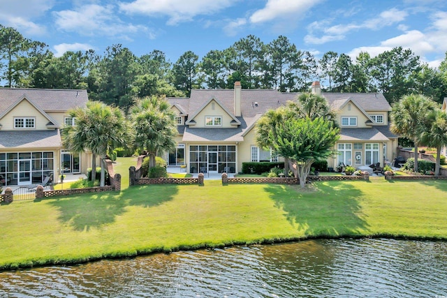 431 Huntington Lake Cir Unit 80, Pawleys Island, SC 29585 - back of house featuring a sunroom, a water view, and a lawn