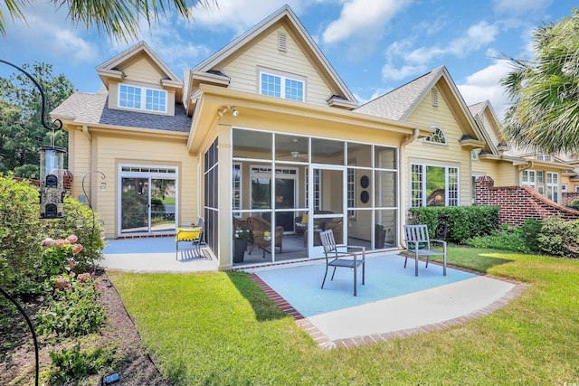 431 Huntington Lake Cir Unit 80, Pawleys Island, SC 29585 - rear view of house featuring roof with shingles, a patio, a sunroom, and a lawn