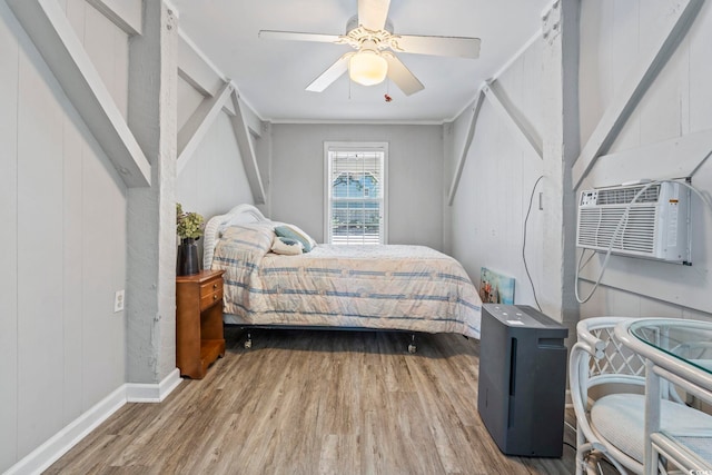 709 Triple Oak Ln, Garden City Beach, SC 29576 - bedroom with wood finished floors, ceiling fan, and an AC wall unit