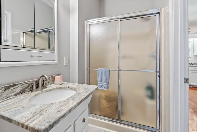 709 Triple Oak Ln, Garden City Beach, SC 29576 - full bath with vanity, a shower stall, and wood finished floors