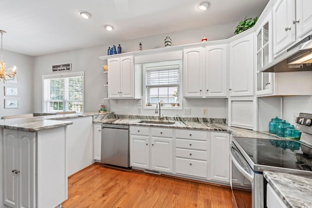 709 Triple Oak Ln, Garden City Beach, SC 29576 - kitchen featuring stainless steel appliances, a peninsula, white cabinetry, and recessed lighting