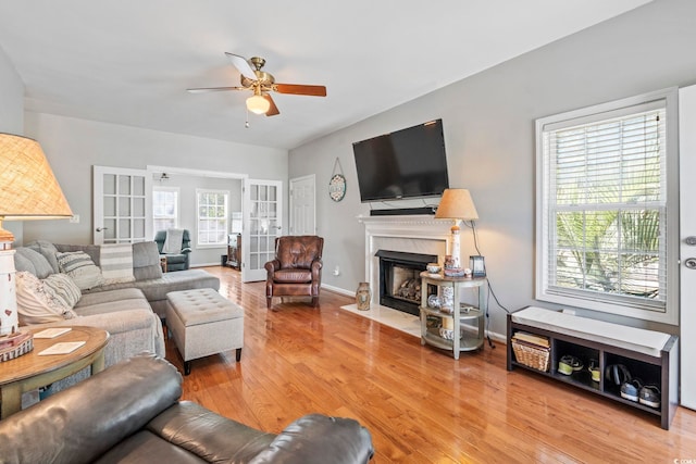 709 Triple Oak Ln, Garden City Beach, SC 29576 - living area with ceiling fan, a high end fireplace, light wood-style flooring, and french doors