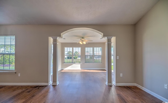 4524 E Walkerton Rd, Myrtle Beach, SC 29579 - spare room featuring ornate columns, arched walkways, and dark wood-type flooring