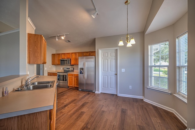 4524 E Walkerton Rd, Myrtle Beach, SC 29579 - kitchen with appliances with stainless steel finishes, track lighting, brown cabinets, dark wood-style flooring, and vaulted ceiling