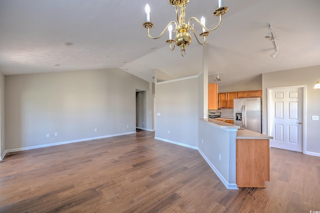 4524 E Walkerton Rd, Myrtle Beach, SC 29579 - kitchen featuring stainless steel fridge, brown cabinetry, lofted ceiling, wood finished floors, and light countertops