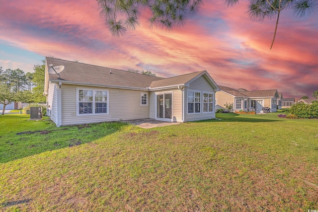 4524 E Walkerton Rd, Myrtle Beach, SC 29579 - back of property at dusk featuring a lawn and a patio area