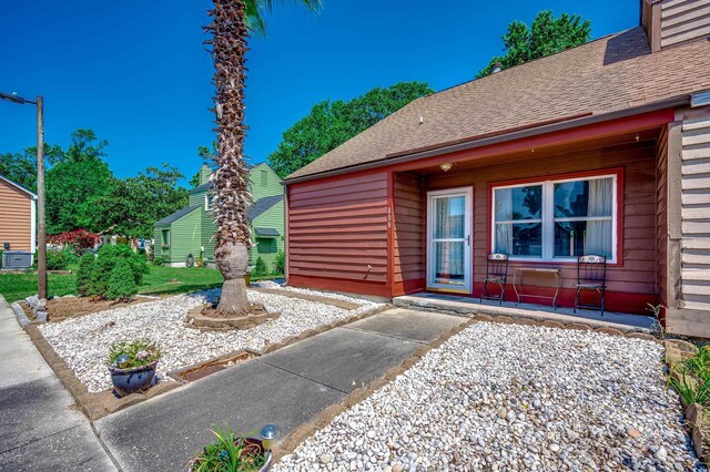 808 Myrtle Ct Unit 808, North Myrtle Beach, SC 29582 - view of exterior entry with roof with shingles
