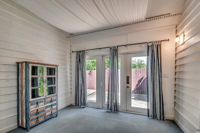 808 Myrtle Ct Unit 808, North Myrtle Beach, SC 29582 - carpeted empty room with plenty of natural light, vaulted ceiling, and wood walls