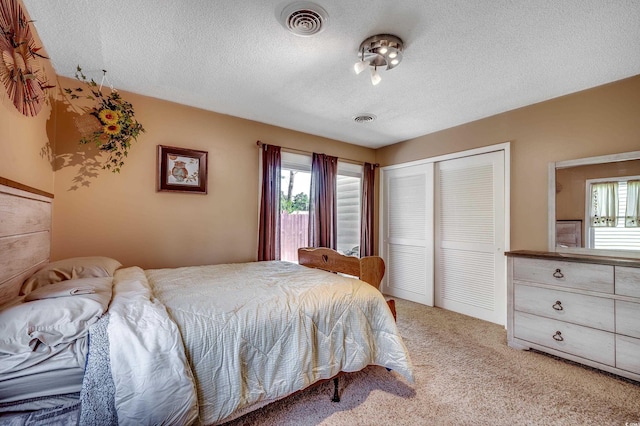 808 Myrtle Ct Unit 808, North Myrtle Beach, SC 29582 - bedroom with multiple windows, a closet, light colored carpet, and a textured ceiling