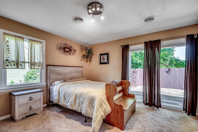 808 Myrtle Ct Unit 808, North Myrtle Beach, SC 29582 - bedroom featuring access to exterior, light carpet, and a textured ceiling