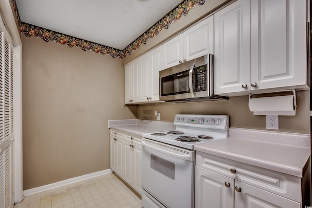 808 Myrtle Ct Unit 808, North Myrtle Beach, SC 29582 - kitchen with electric range, stainless steel microwave, a heating unit, white cabinets, and light countertops