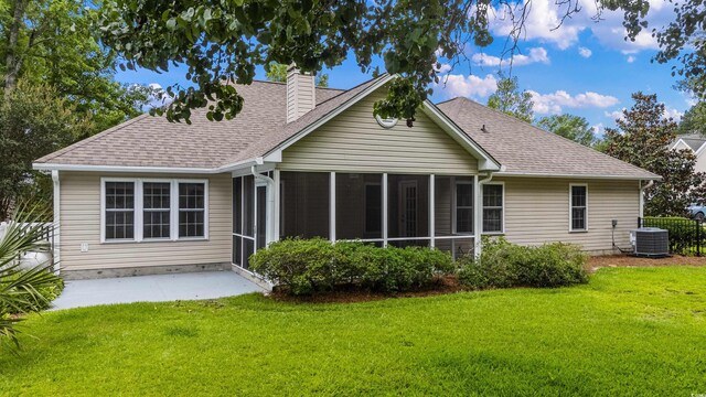 104 Ashton Cir, Myrtle Beach, SC 29588 - rear view of property featuring a chimney, a sunroom, and a lawn