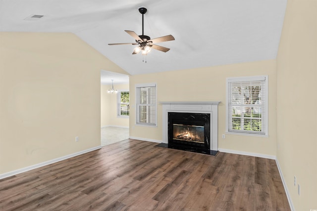 104 Ashton Cir, Myrtle Beach, SC 29588 - unfurnished living room with vaulted ceiling, a fireplace, wood finished floors, ceiling fan, and a chandelier