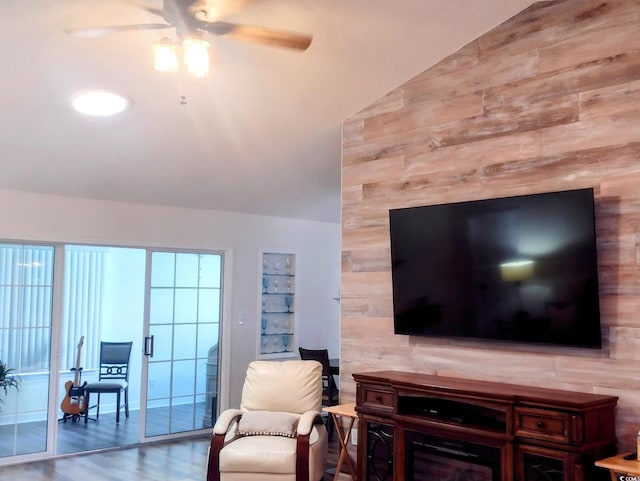 219 Birdie Way, Longs, SC 29568 - living room featuring ceiling fan, lofted ceiling, wood finished floors, wooden walls, and a desk