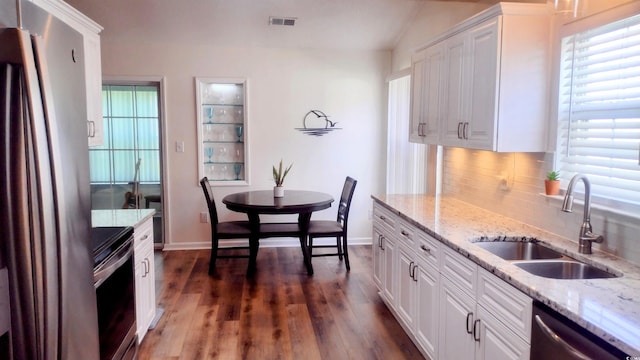 219 Birdie Way, Longs, SC 29568 - kitchen with stainless steel appliances, backsplash, plenty of natural light, and vaulted ceiling